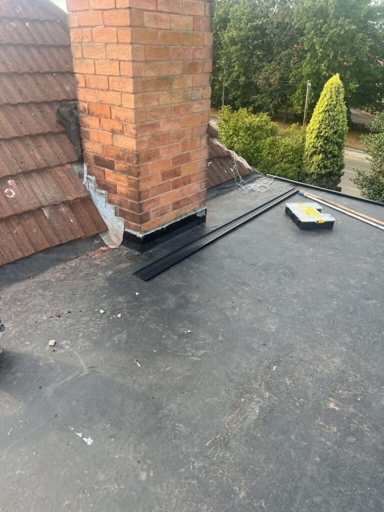 This is a photo of a flat roof which has just been repaired, there is also a chimney stack and some leadwork has also been dressed. Works carried out by North Hykeham Roofing Repairs