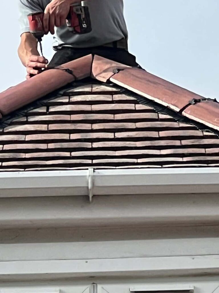 This is a photo of one of the operatives of North Hykeham Roofing Repairs installing new ridge tiles